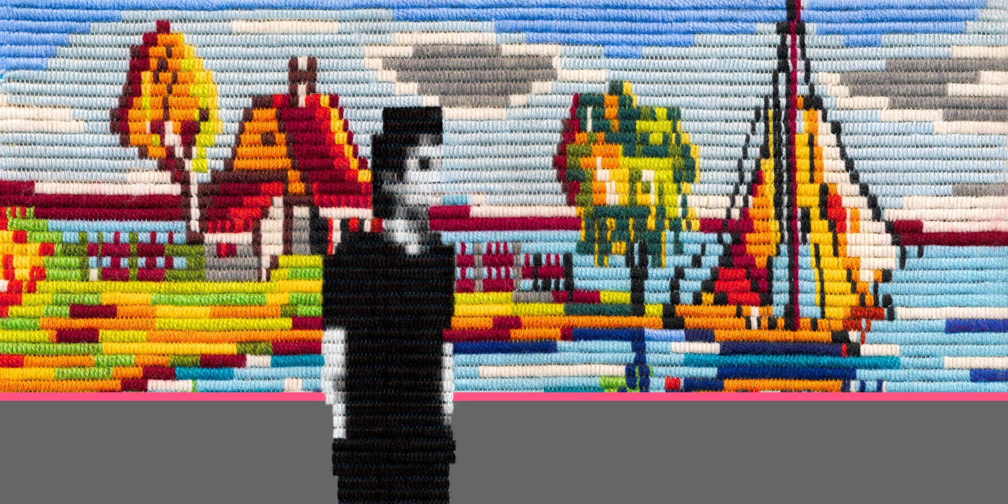 A figure in black standing before a large street-art mural made of beads, depicting a lakeside scene with boats, trees and buildings.