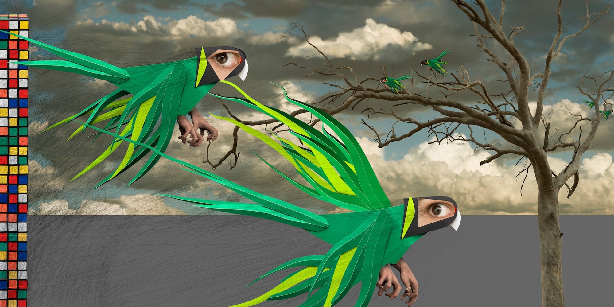 Two parrots with human eyes and beaks and green flowing feathers, on the ground before a barren tree under a cloudy sky, with smaller green birds flying near the tree.
