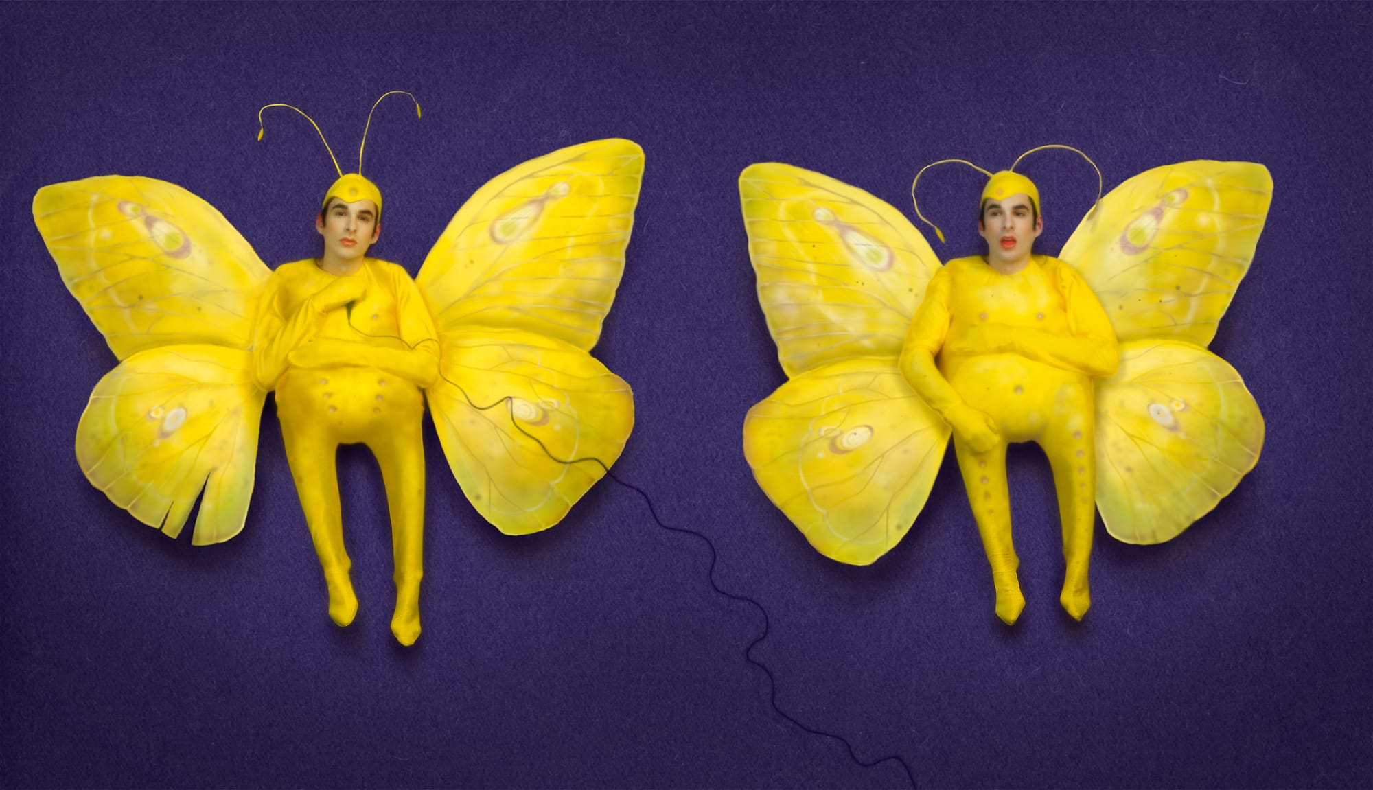 Self-portrait as an infant in a butterfly costume, dark ground.