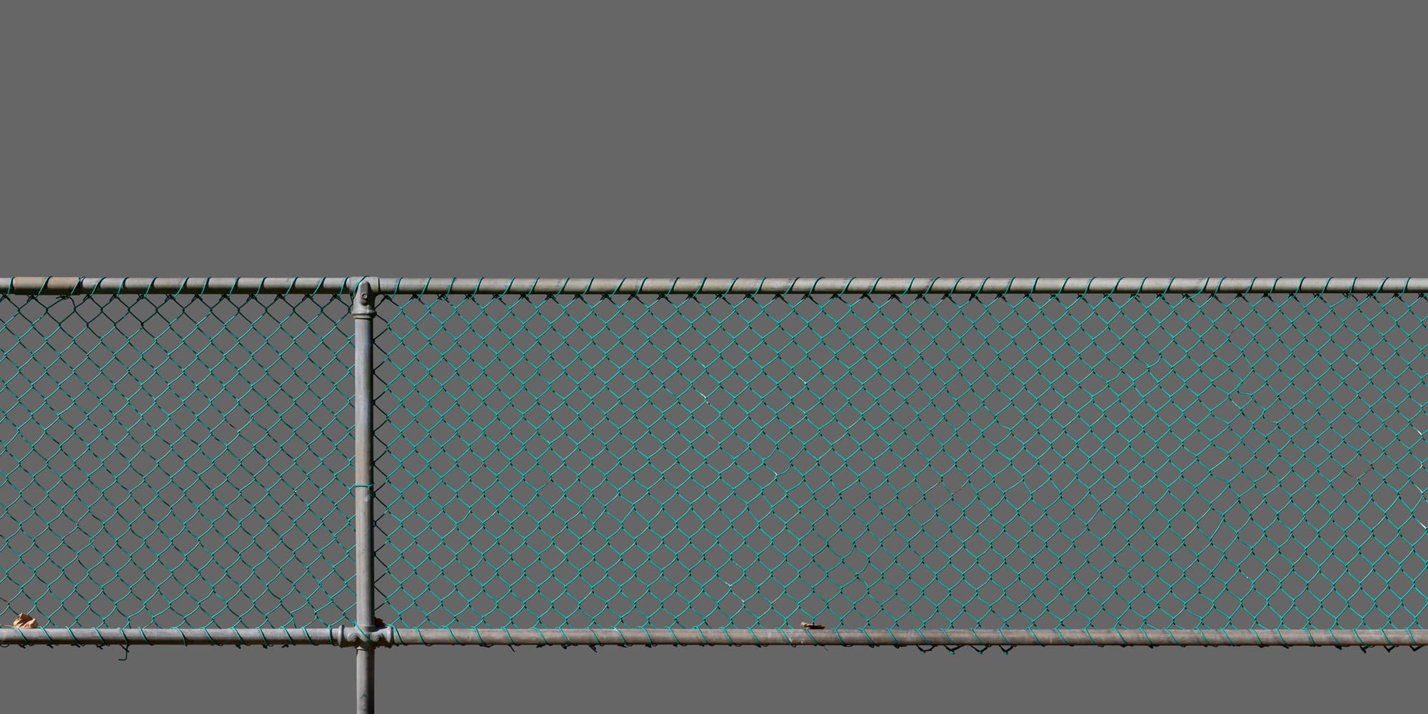 A chain-link fence coated in turquoise plastic, against a solid grey background.