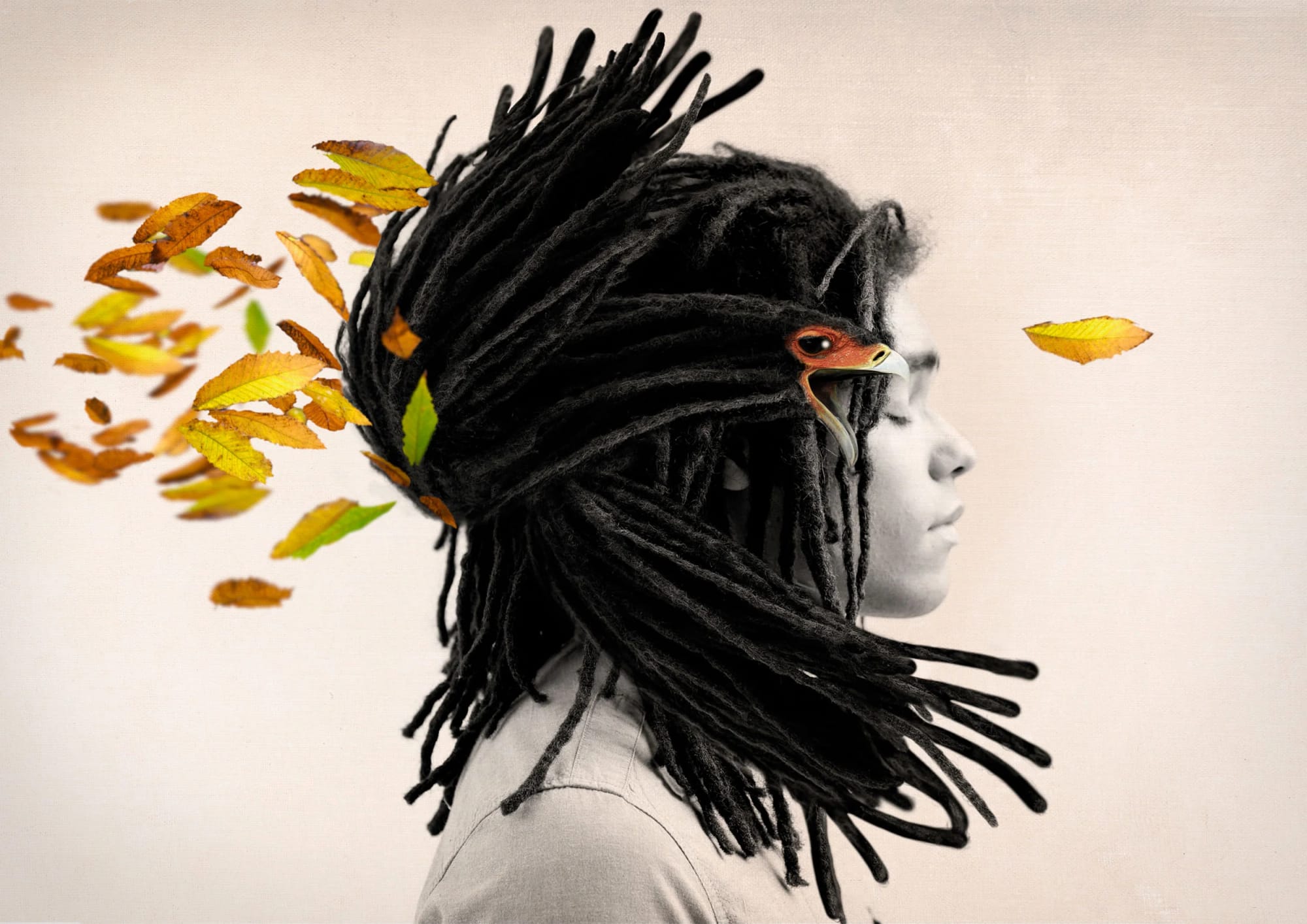 A person with dreadlocks has a bird's head replacing their own face, with autumn leaves flowing from the dreadlocks.