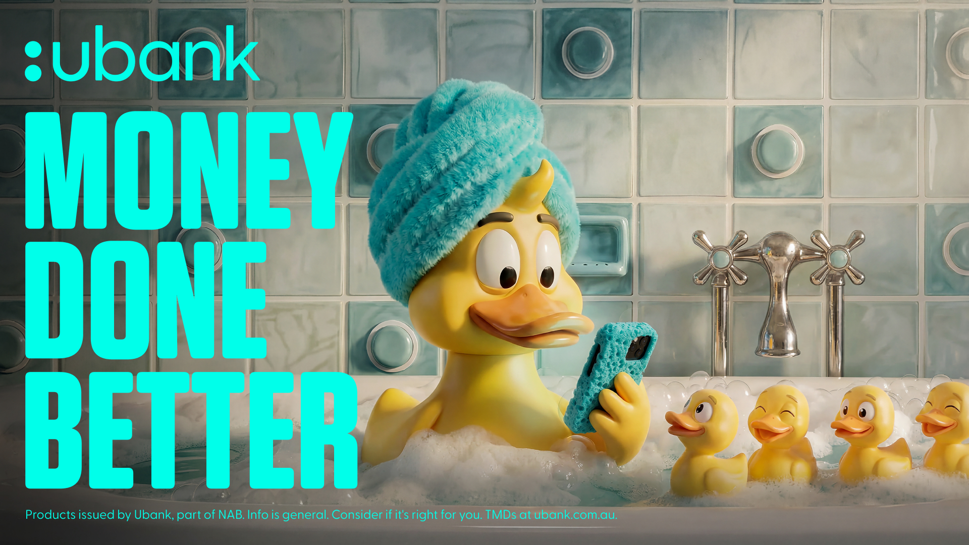 A yellow duck with a towel wrapped around her head checks a phone in a bath, with ducklings beside her and turquoise Ubank lettering.